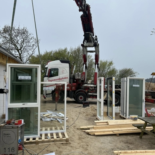 Krankørsel med vindue løftet fra palle ved husbyggeri.